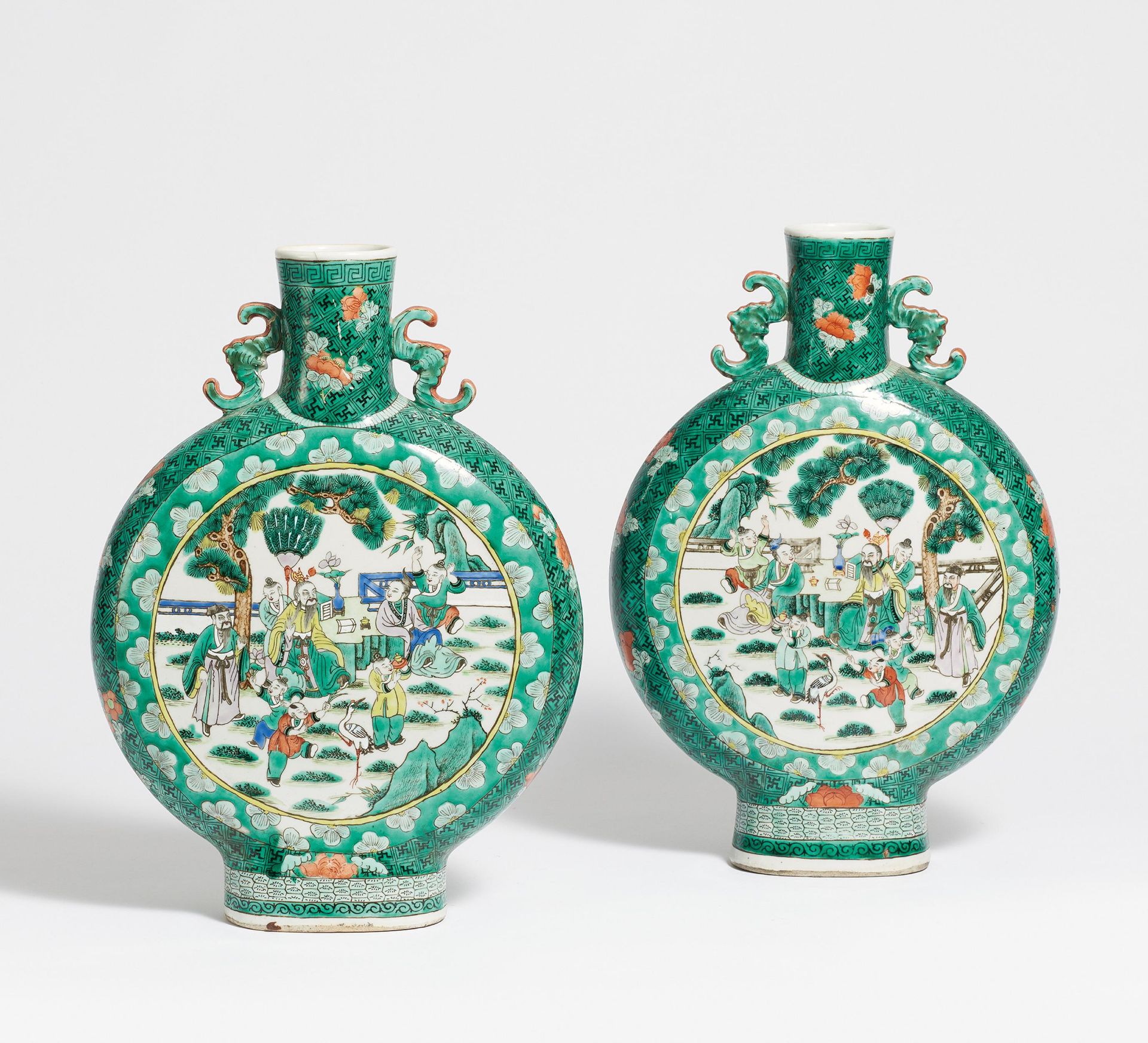 A PAIR OF MOON FLASKS WITH SCHOLARS. China. Before 1900. Heavy porcelain painted in famille verte.