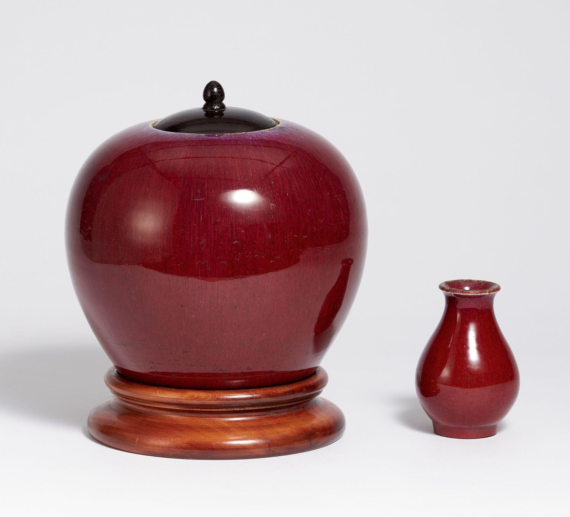 BULBOUS JAR AND SMALL VASE IN OX BLOOD RED. China. 19th c. Porcelain with ox blood red flambé glaze.