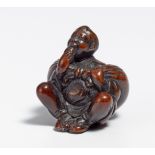 NETSUKE: FARMER WITH LARGE FUROSHIKI BUNDLE. Japan. 19th c. Dark wood, carved. Denoted: So-min. H.