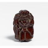 NETSUKE: NÔ ACTOR WITH SWORD. Japan. 19th c. Dark reddish brown wood with lighter colored part on