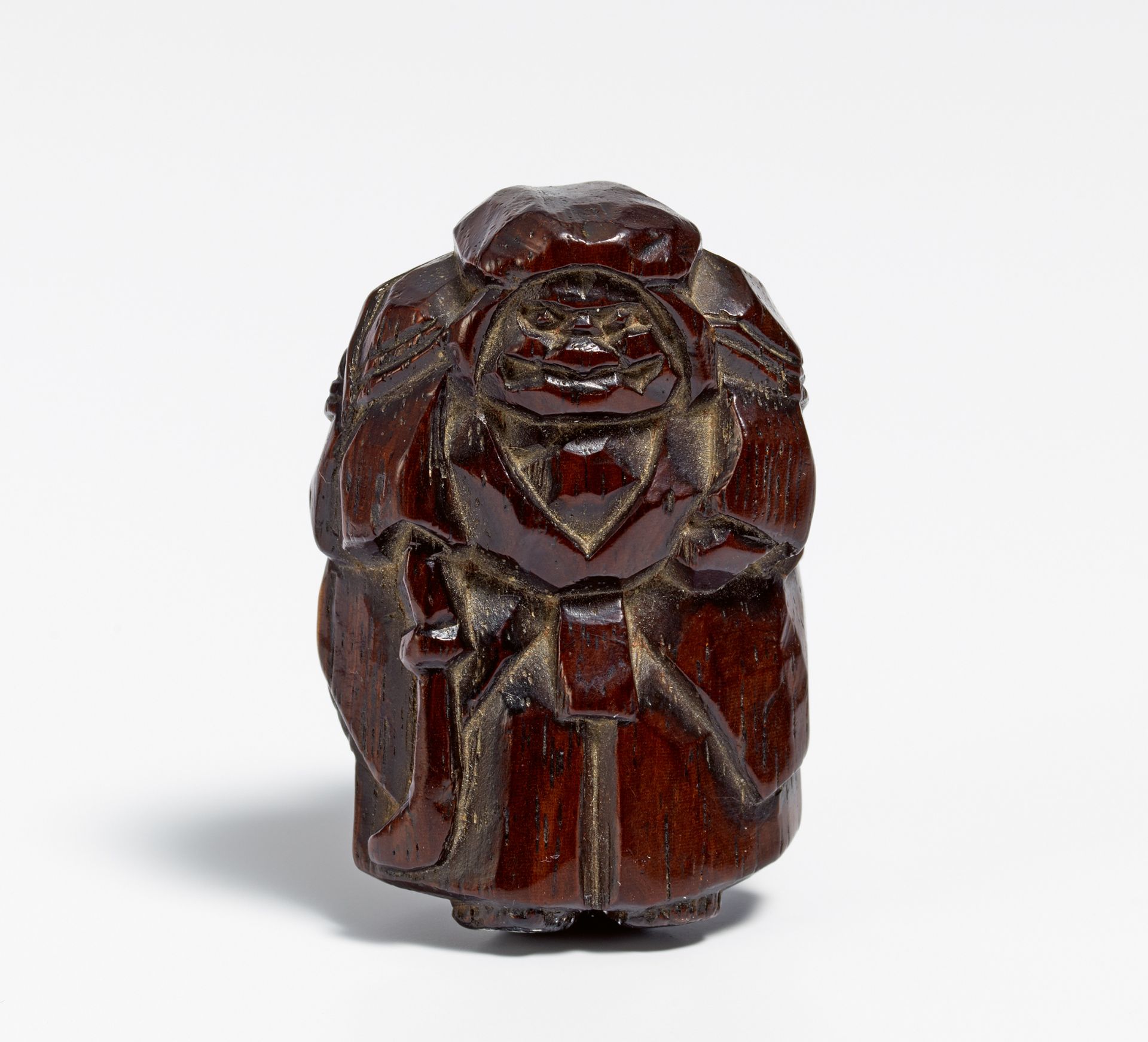NETSUKE: NÔ ACTOR WITH SWORD. Japan. 19th c. Dark reddish brown wood with lighter colored part on