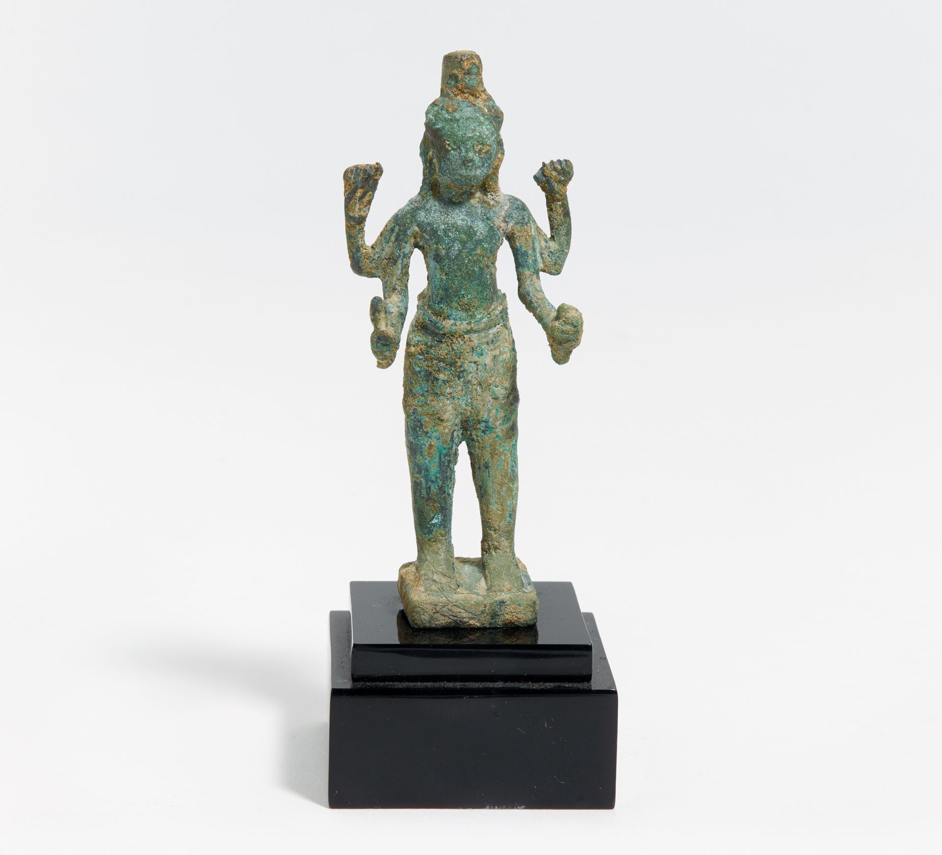 SMALL FIGURE OF THE FOURARMED VISHNU. Khmer. Angkor period. Ca. 12th/13th c. Bronze with green