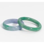 TWO BANGLES FROM JADE. China. 19th-20th c. Green, resp. green-purple Nephrite jade. Ø outside/