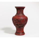 VASE OF RED CARVED LACQUER WITH SCHOLARS IN LANDSCAPE. China. Early 20th c. Red carved lacquer,