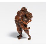 NETSUKE OF TWO SUMÔTORI AT KAWAZU. Japan. 19th c. Dark hardwood, finely carved. Under the foot