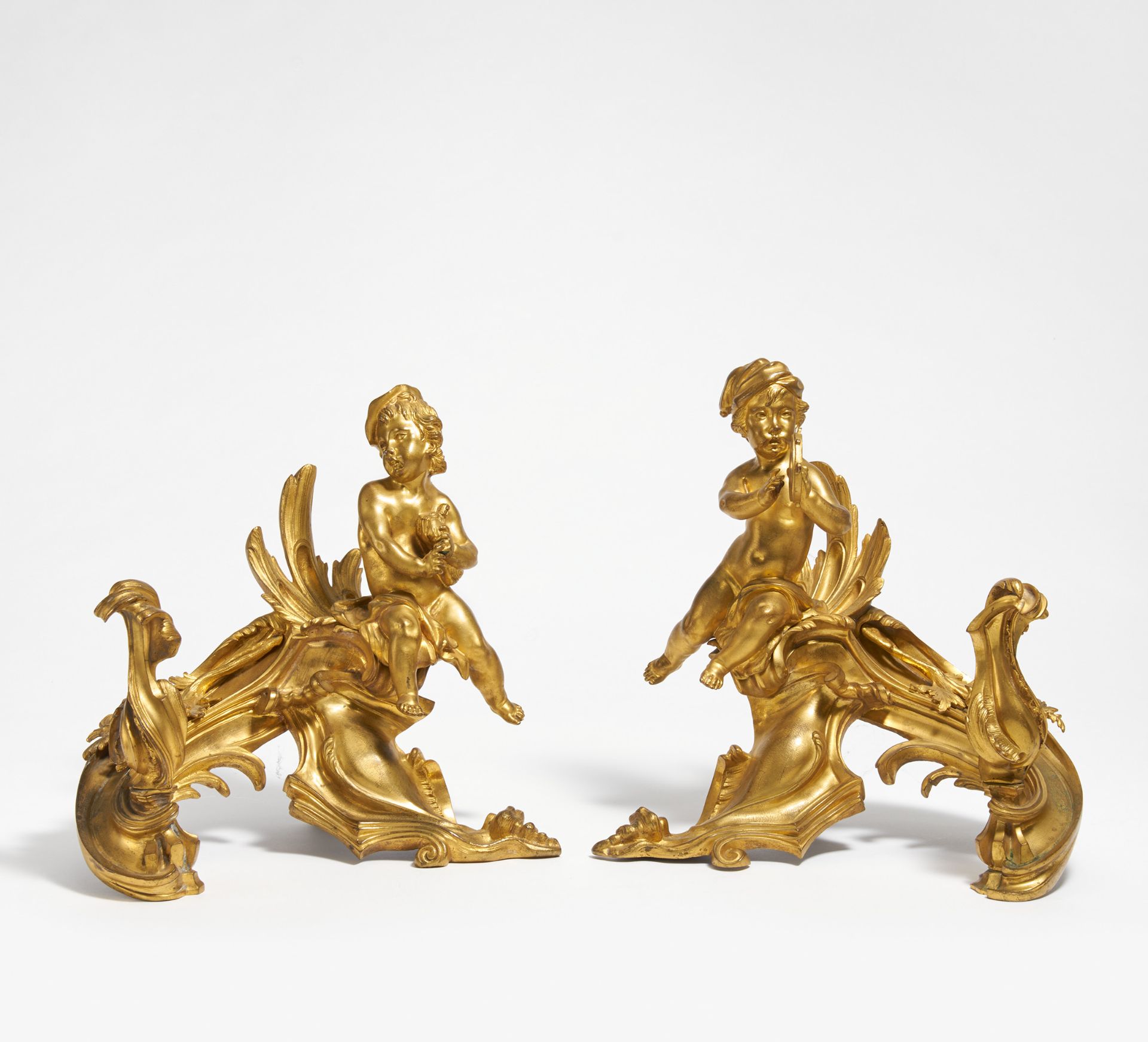 PAIR OF LARGE ANDIRONS WITH PUTTI WITH INSTRUMENTS STYLE LOUIS XV. France. Late 19th century. Gilt