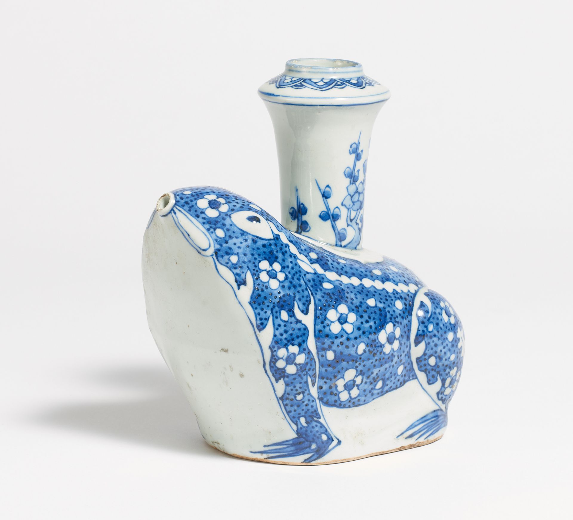 KENDI IN THE SHAPE OF A FROM WITH FLOWERING PLUM. China. Porcelain, painted underglaze blue.