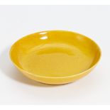SMALL YELLOW-GLAZED DISH. China. Qing Dynasty. Tongzhi period (1861-1875). Porcelain, inside and