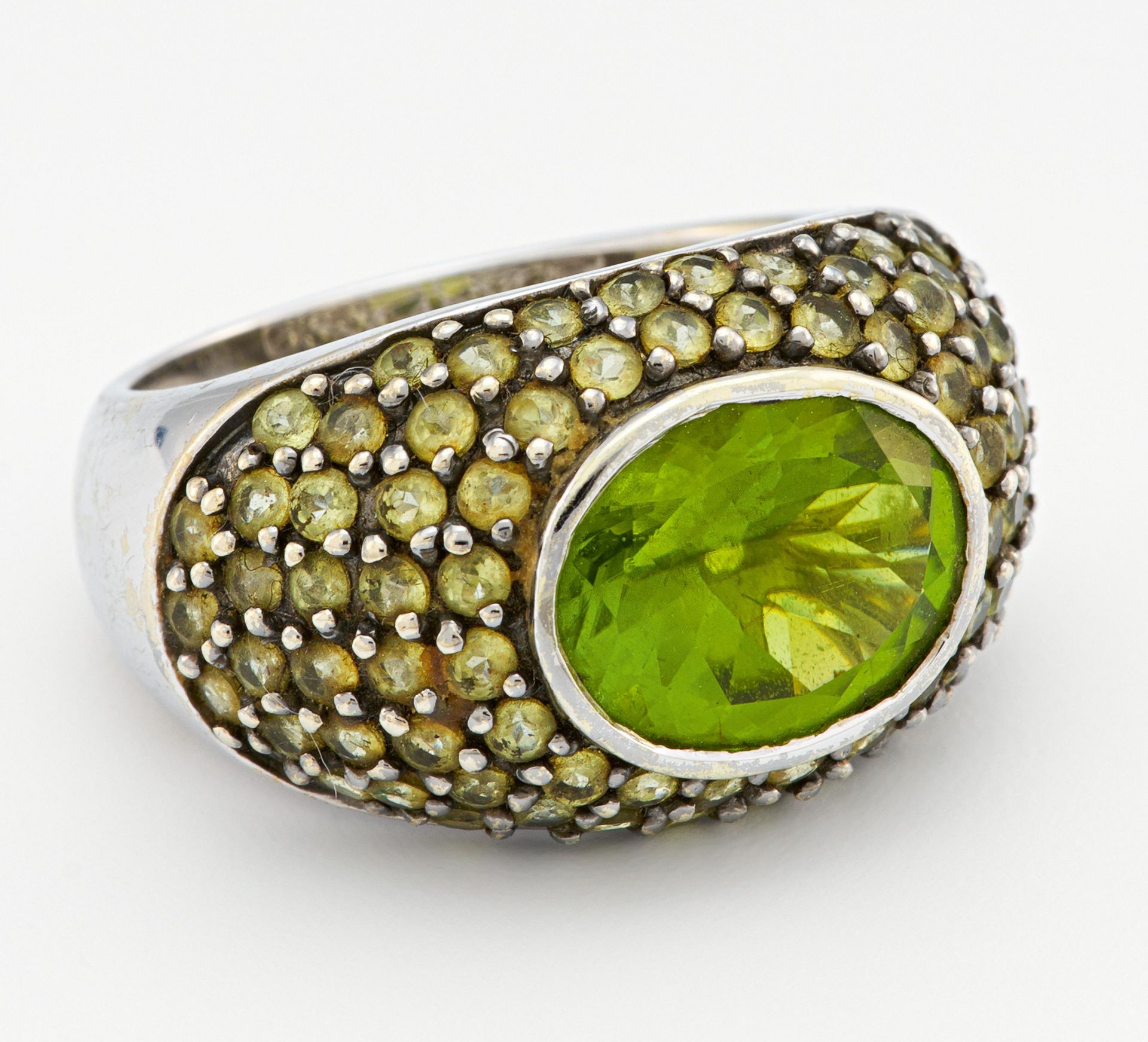 PERIDOT-RING. 585/- Weißgold, Punze, Gesamtgewicht: ca. 8,5 g. EU-RM: 55. Ca. 51 kleine, runde,