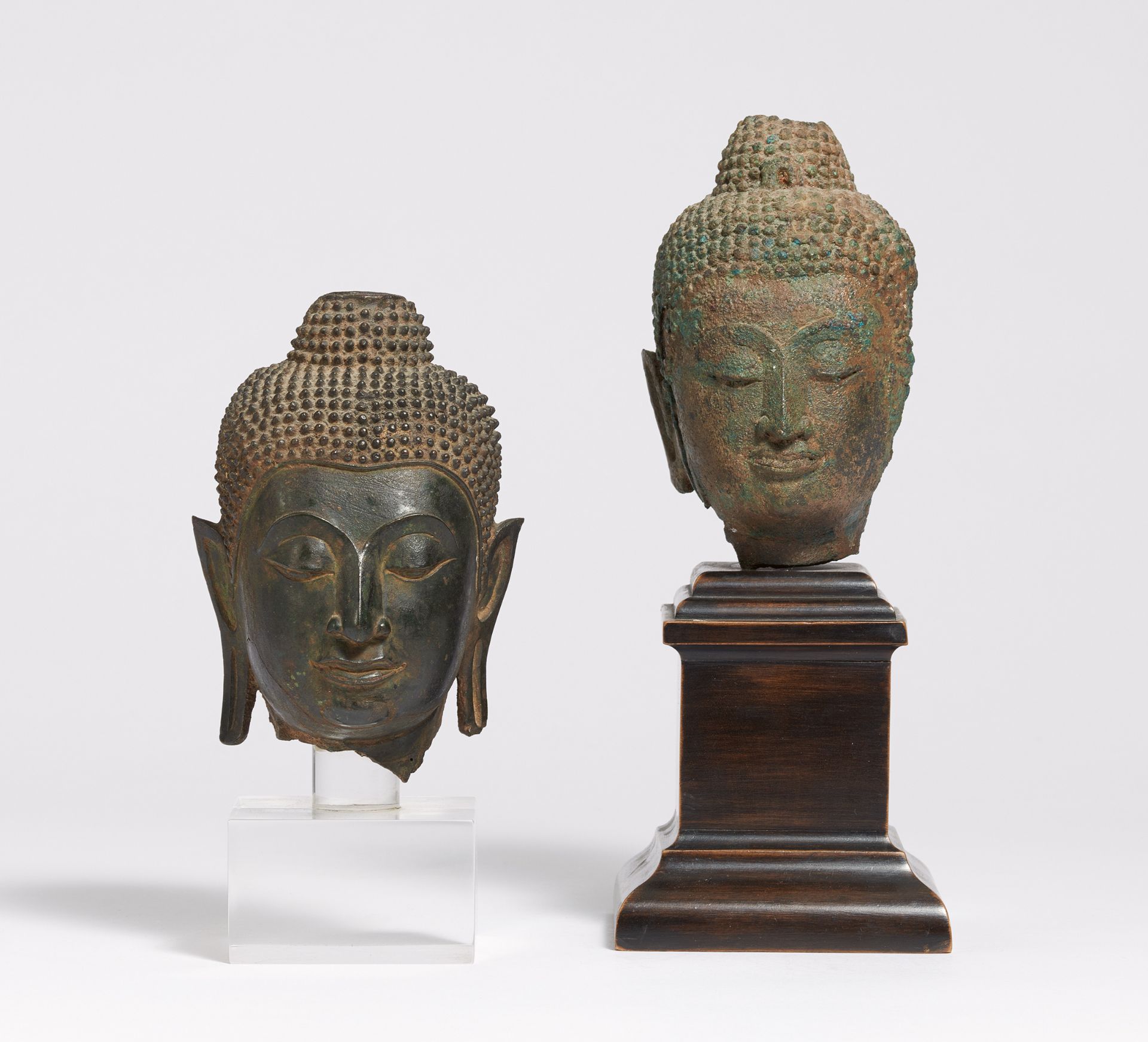 TWO SMALL BUDDHA HEADS. Thailand. Ayutthaya period (1350-1767). Bronze with dark patina, one with