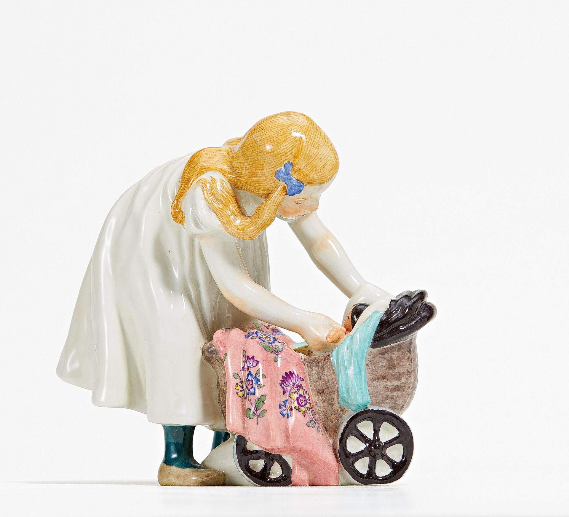 Porcelain figurine of girl with a doll's pram