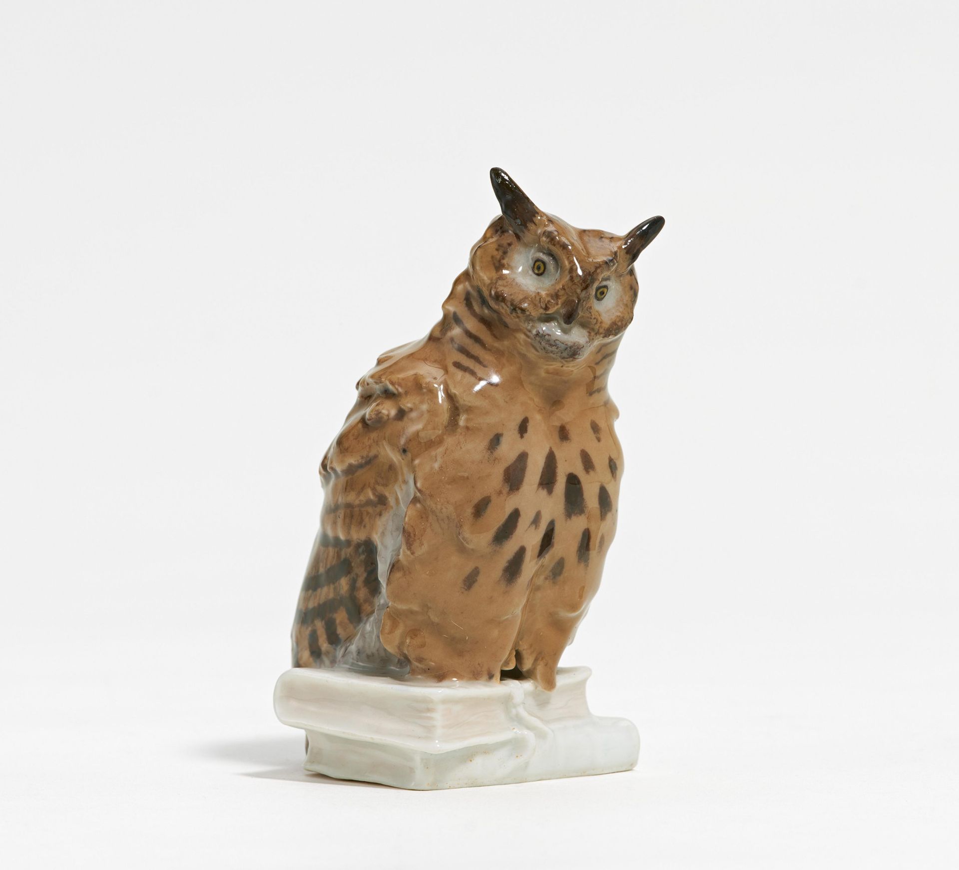 Small porcelain owl on book stack