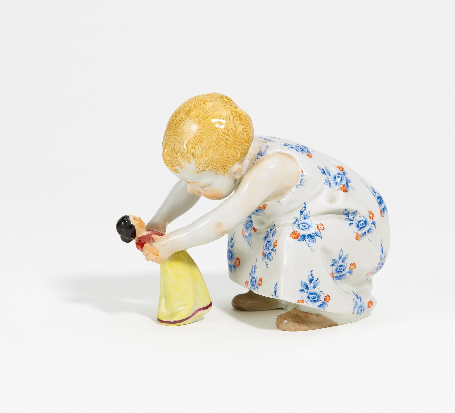 Porcelain figurine of child with doll