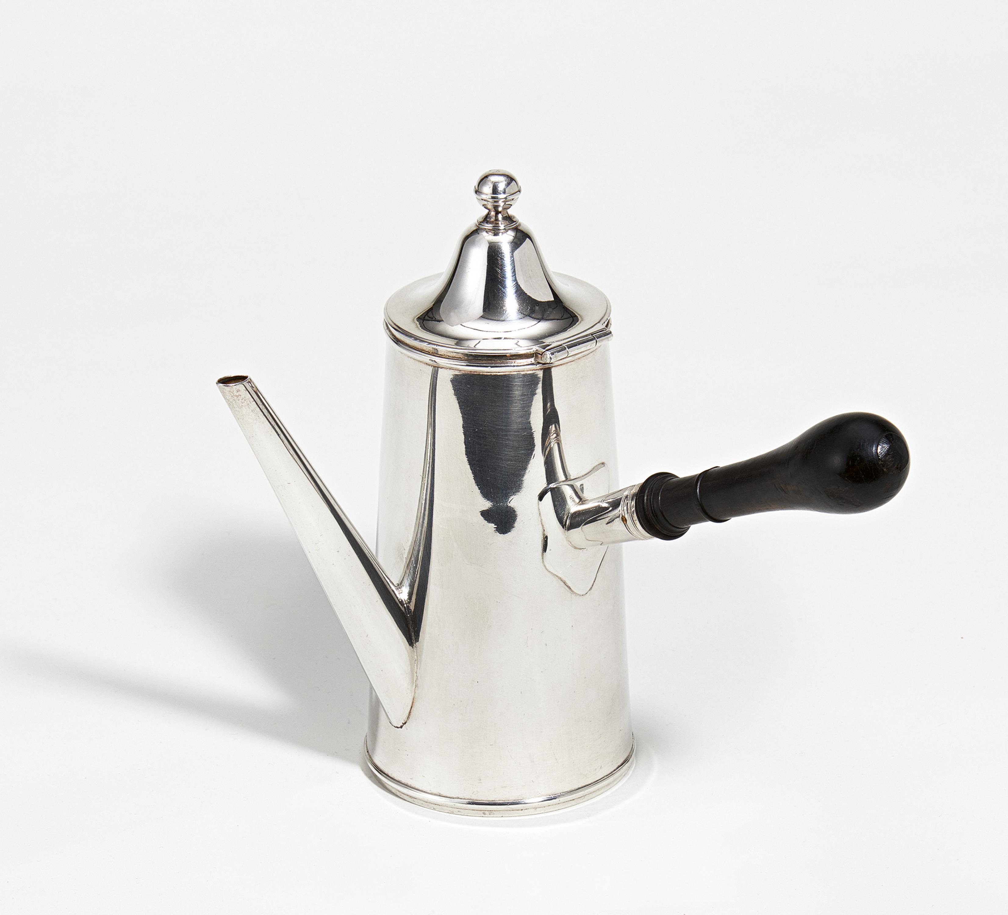 Silver coffee pot with side handle and sleek body