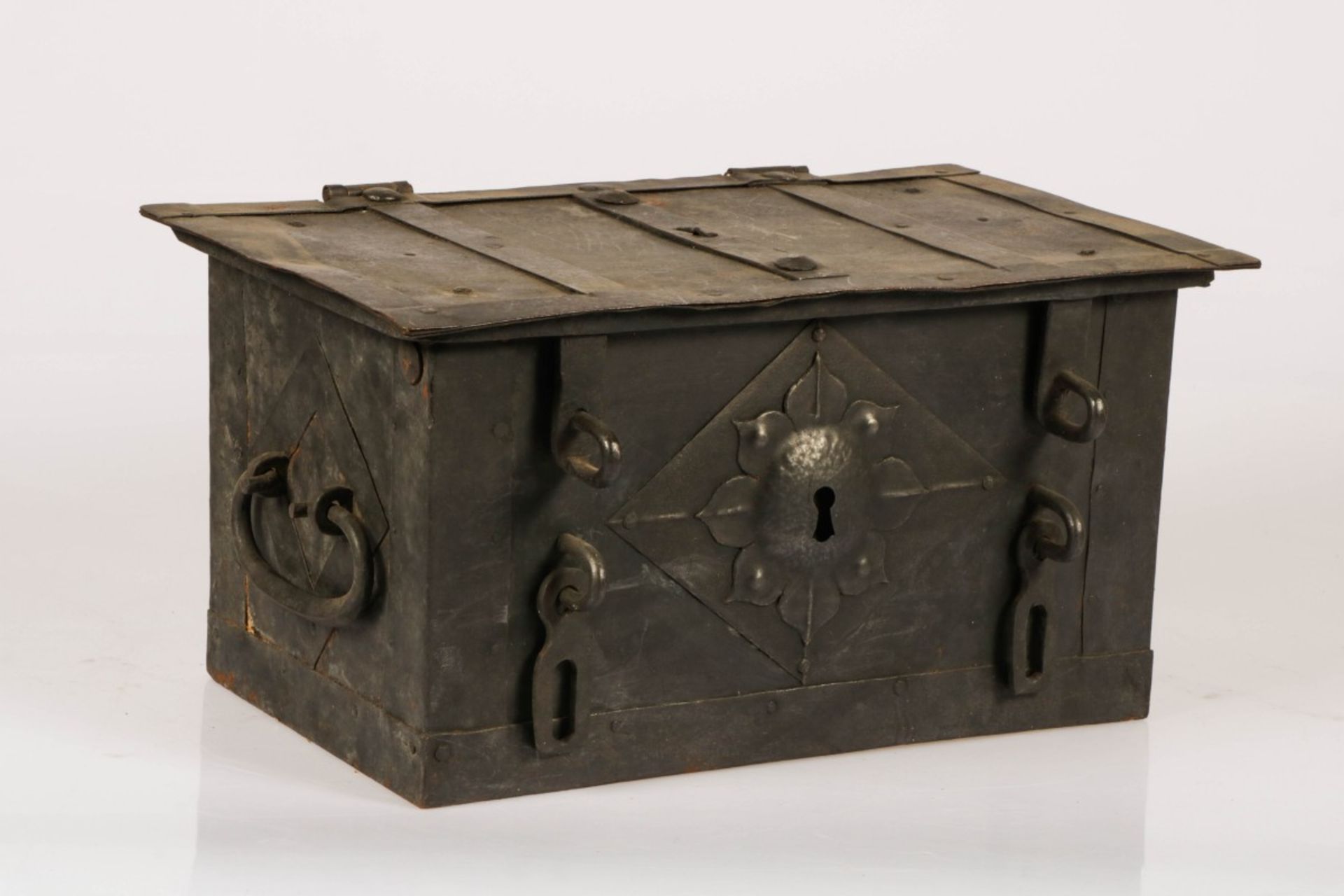 A wrought iron strongbox with iron mounts and lockplate.