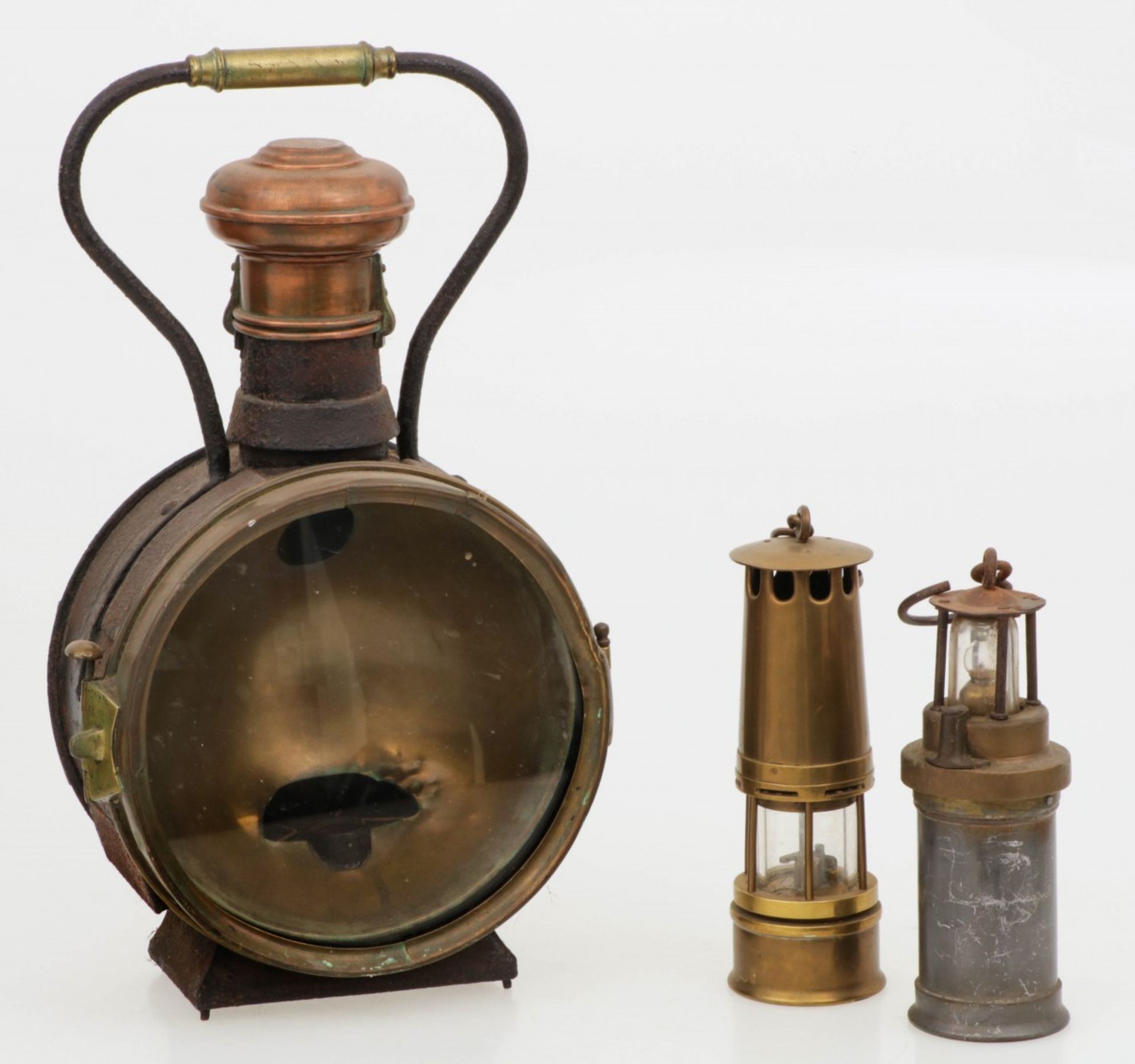 A railway lantern together with two miners' lamps, Dutch, ca. 1900 and later.