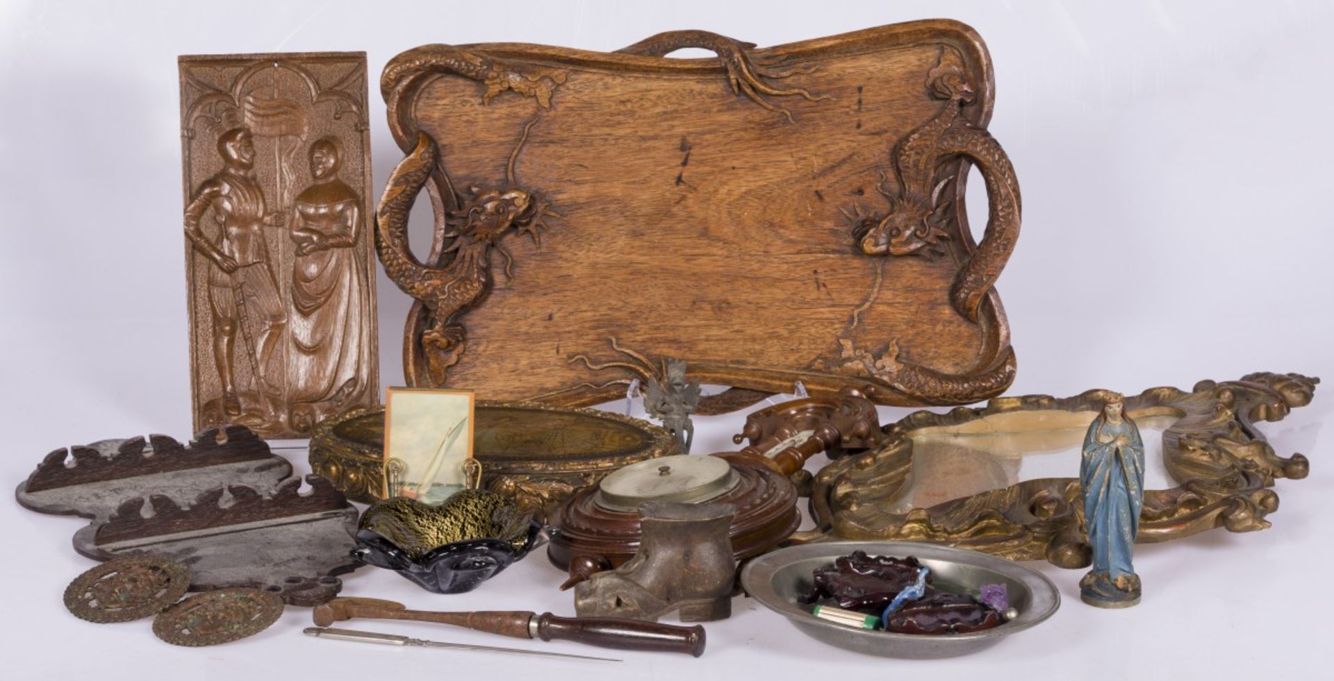 A lot of various items including a wall mirror and a barometer.