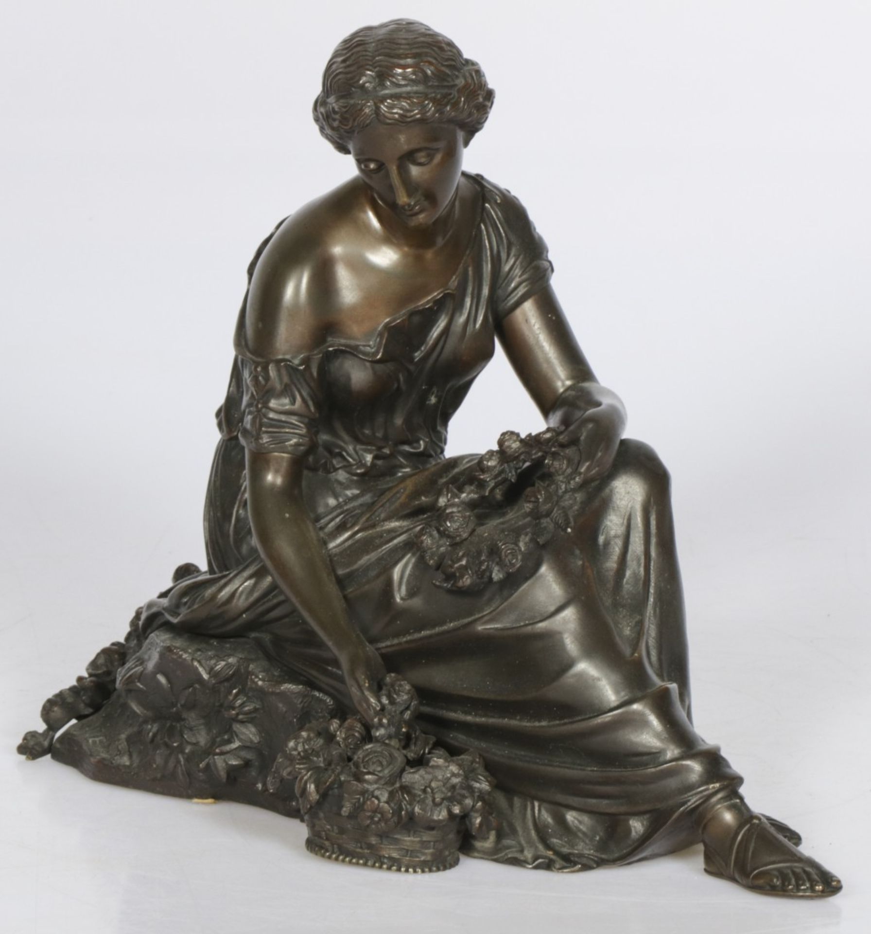 A bronze sculpture of a seated Pomona.