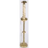 A brass easter-candleholder, fitted as a floorlamp, 20th century.
