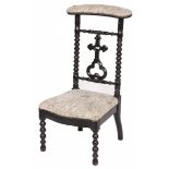 A blackened wooden prayer chair with turned legs and stretchers, 1st quarter of the 20th century.