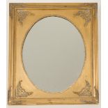An oval mirror with gold painted decorative frame, 20th century.