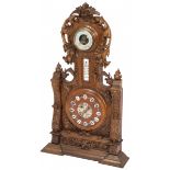 A richly carved wooden clock, Germany, 20th century.