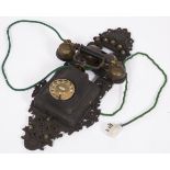 A cast iron and bakelite wall telephone, Sweden, early 20th century.