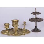 A bronze smoking set with cast iron pipe holder, late 19th century and later.