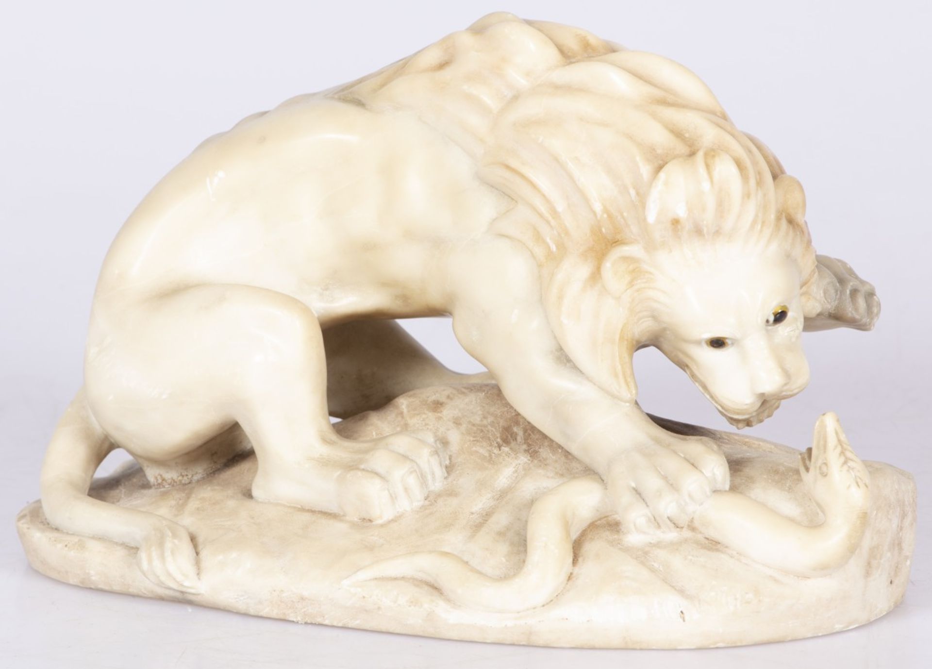 A marble sculpture of a lion fighting a snake, 1st half 20th century.