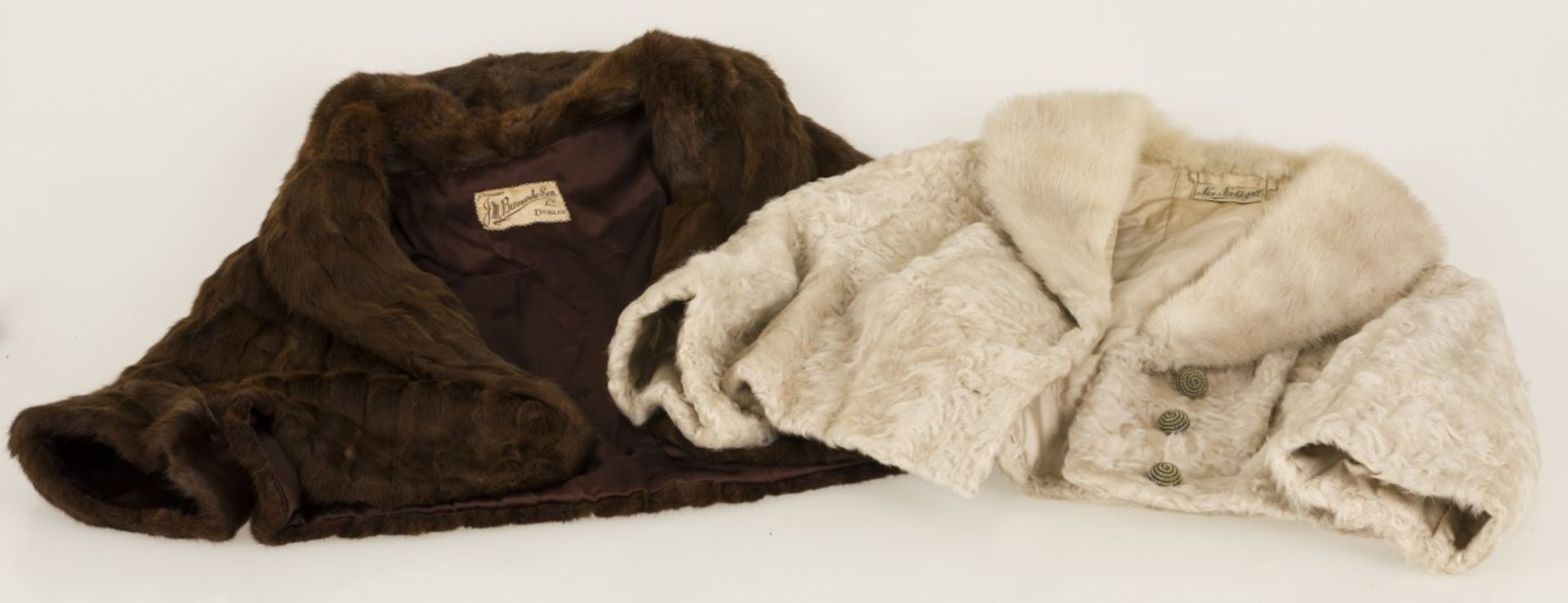 A lot of (2) short fur coats made of astrakhan fur and mink fur.