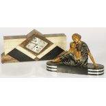 An Art Deco mantle clock and a sculpture of mother with child, France, ca. 1920.