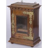 An oak smokers cabinet with brass fittings.