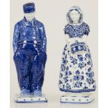 A set of (2) earthenware figures, a farmer and his wife in traditional dress, "De Porceleyne Fles De