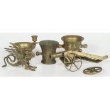 A lot comprising a bronze signal cannon, (3) mortars and a candle holder in the shape of a dragon.