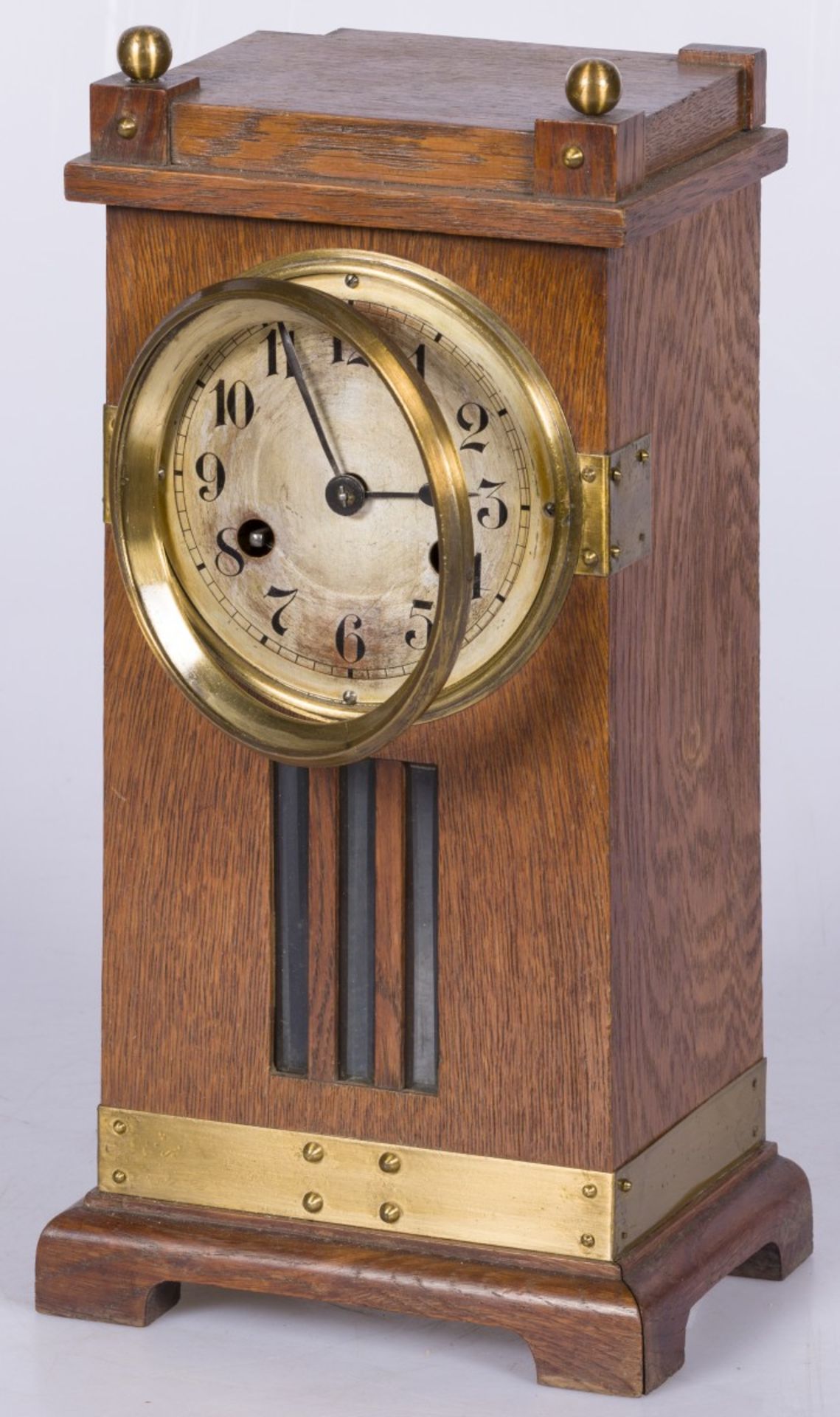 An European 'Arts & Crafts' style oak mantle clock with brass fittings.