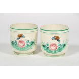 Two ceramic cachepots, polychromed flower decor, France, early 20th century.
