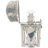 Perfume bottle in silver pouch.