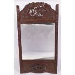 A mirror frame with Balinese carvings, Indonesia, 20th century.