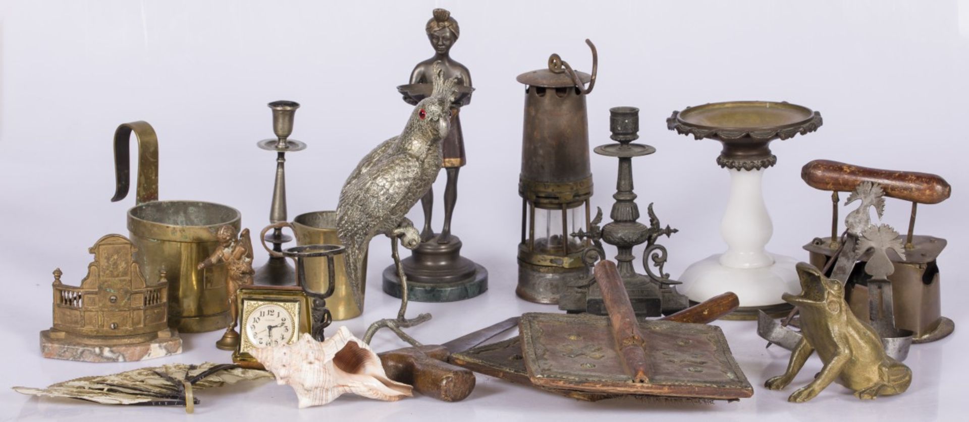 A lot of miscellaneous items including a miner's lamp and various sculptures.