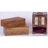 A lot consisting of (2) Indonesian woodcarving chests and a miniature cabinet with inlay, 20th centu
