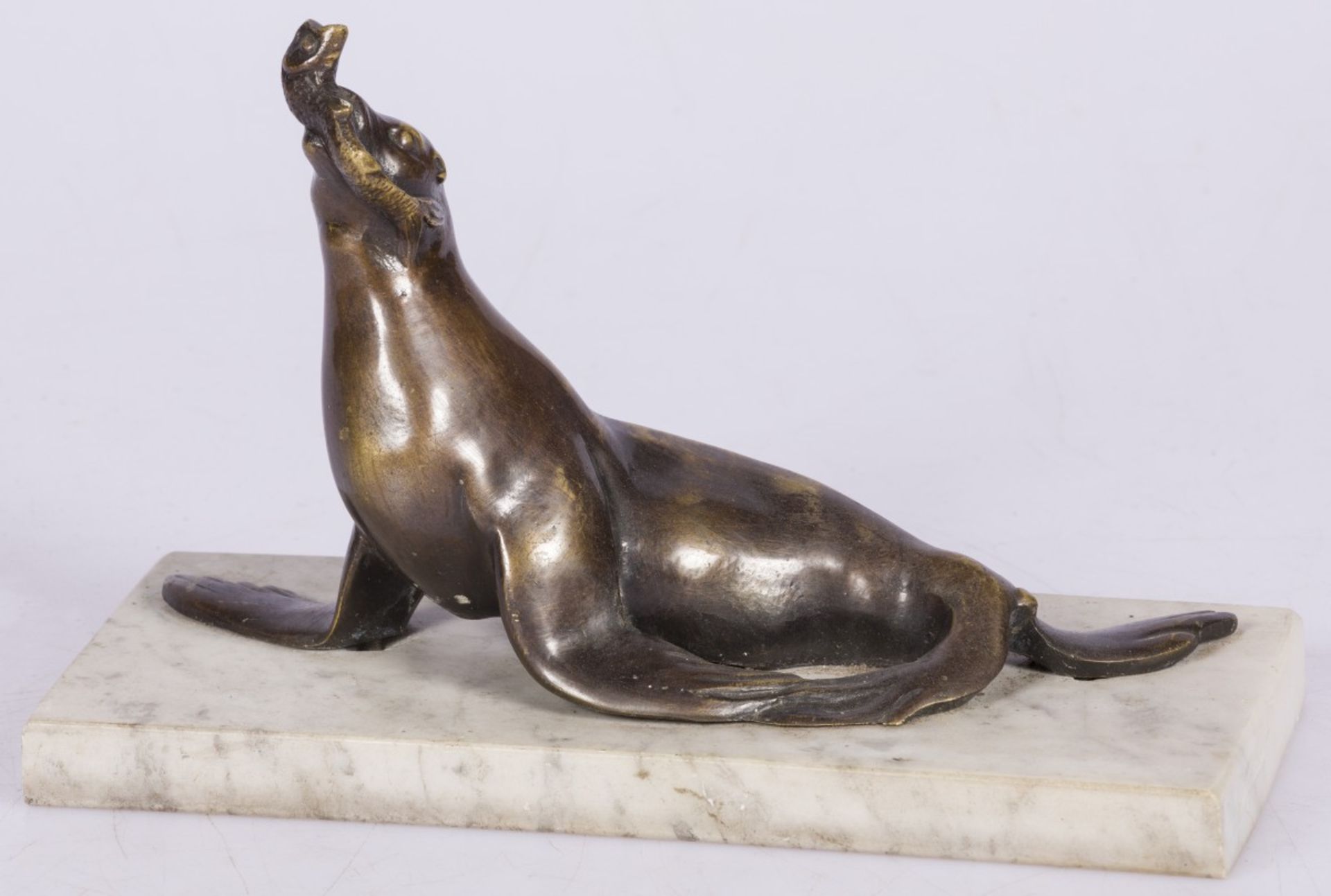 A bronze sculpture of a seal with fish in its beak, France, 2nd quarter 20th century.