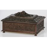 A wooden sewing box with carved decorative border, circa 1900.