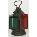 A metal oil lamp transformed into a traffic light with colored plexiglass.