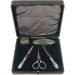 Manicure set in silver pouch.