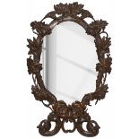 An oval mirror with carved frame, Germany, ca. 1900.