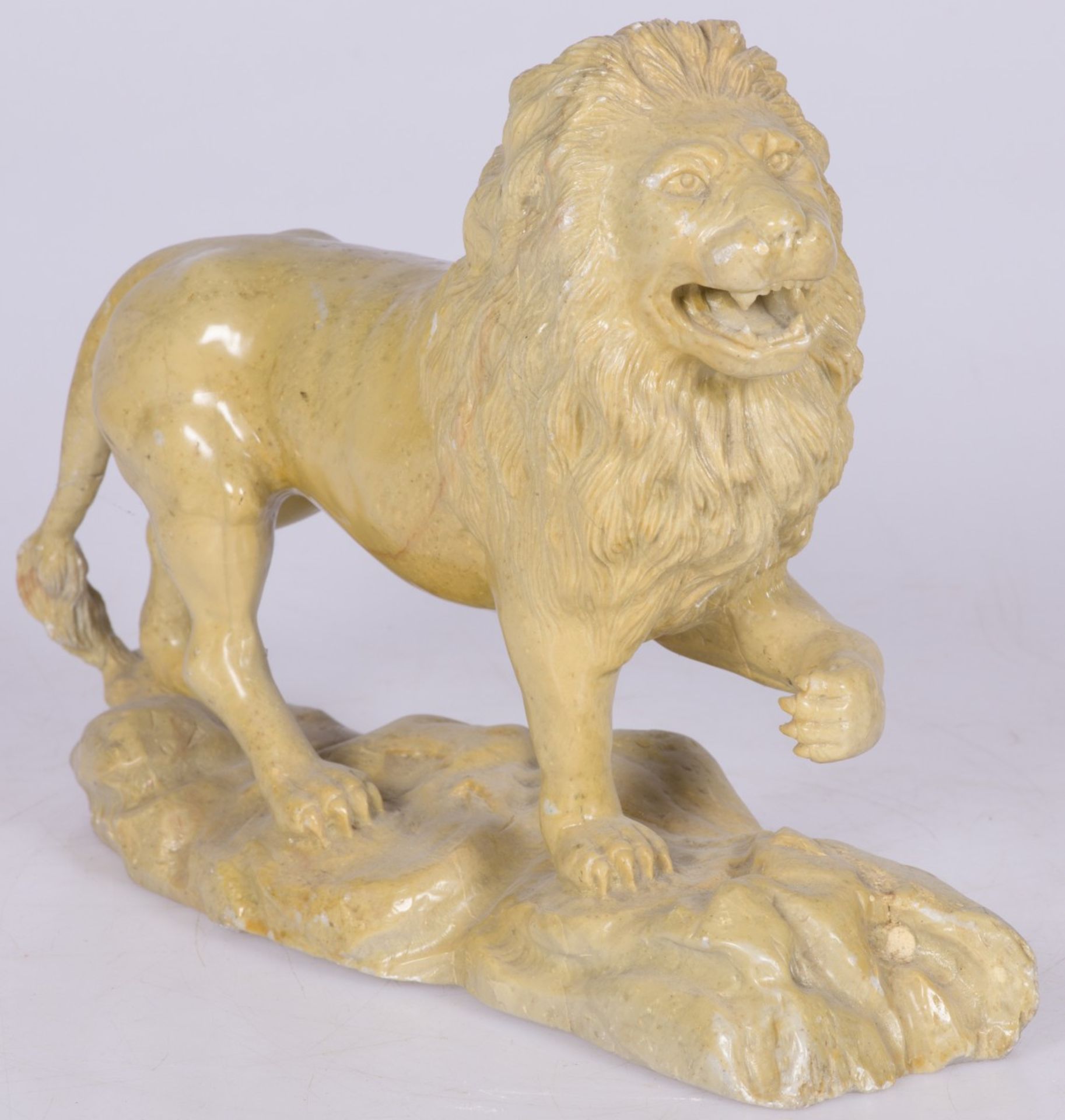 A stone sculpture of a walking lion, France, 2nd quarter 20th century.