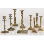 A lot of (4) pairs of bronze candle holders and one separate candle holder.