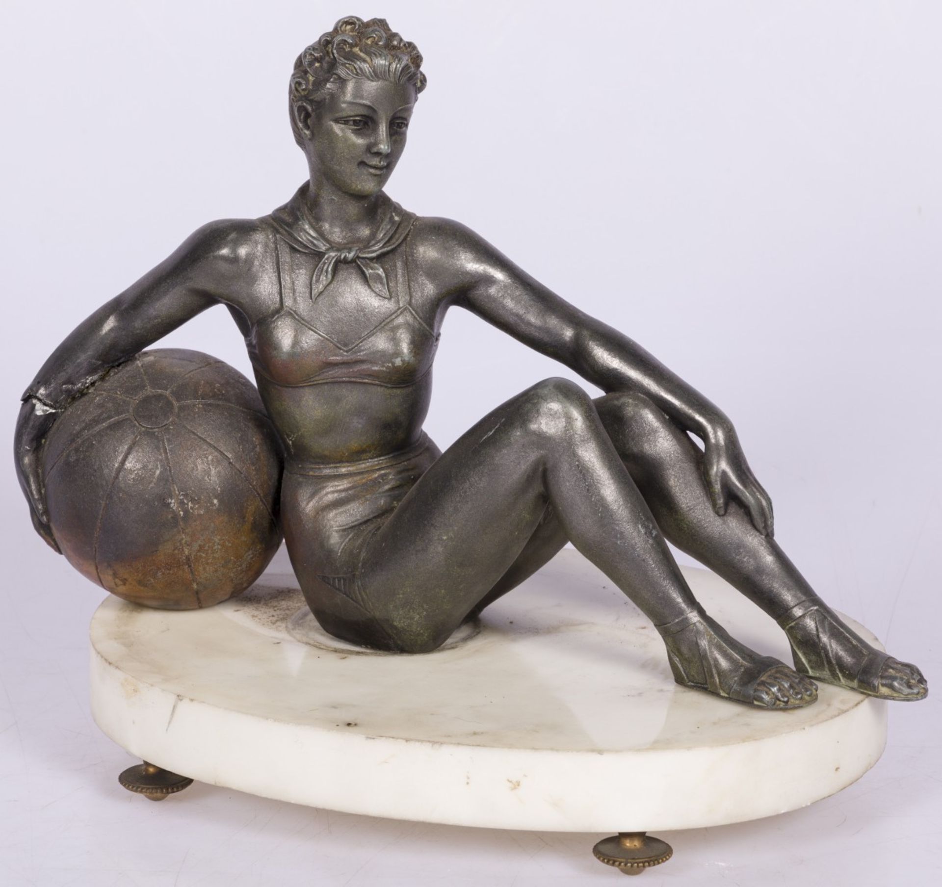 A bronze statuette of a seated turning lady with large ball, France, mid. 20th century.