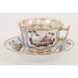 A porcelain cup and saucer with landscape decor, France 19th Century.