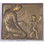A bronze wall plaque with depiction of a mother and child.